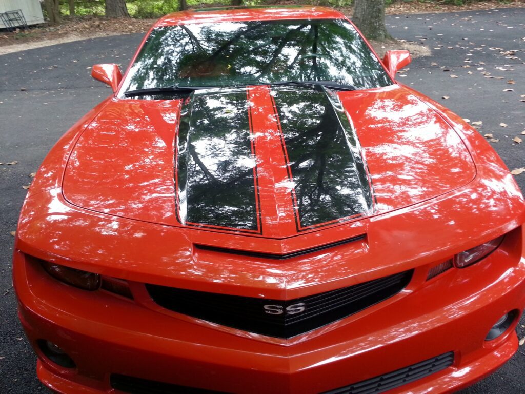 A red car with painted hood